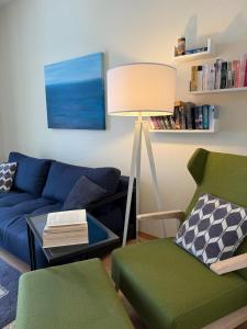 a living room with a blue couch and a lamp at Fürstenhof Sassnitz in Sassnitz +43 photos