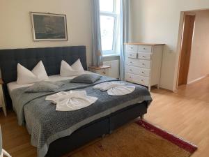 a bedroom with a bed with two towels on it at Fürstenhof Sassnitz in Sassnitz