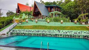 a house with a swimming pool in front of a house at Cinnamon Crown in Matara