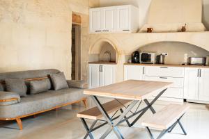 a living room with a couch and a table at Domaine de la batelle in Arles