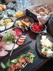 a table topped with lots of different types of food at Fischstübchen Neeberg Apt 1 – Wald und Wiese in Krummin