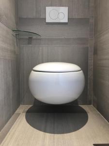 a bathroom with a white toilet in a room at Elixxir in Cap d'Agde