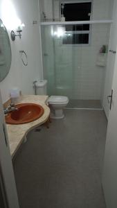 a bathroom with a sink and a toilet at Apê Ponta da Praia Santos in Santos