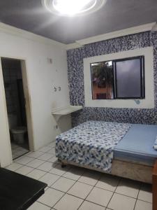 a bedroom with a bed and a flat screen tv at Hotel Panorama do Mar - Praia do Futuro in Fortaleza