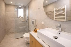 a bathroom with a sink and a shower at A Comfortable Stay with Balcony and Easy Parking near Kalamata Center in Kalamata