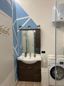 a bathroom with a sink and a washing machine at Swinburne in Genoa