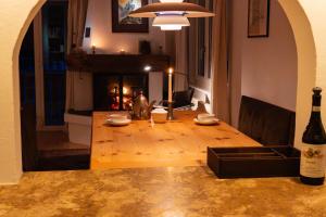 a living room with a wooden table and a fireplace at Casa Nonna in Lenzerheide