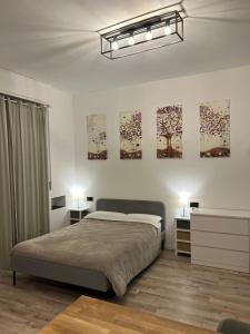 a bedroom with a bed and some paintings on the wall at Swinburne in Genoa