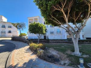 a tree in front of a white building at Donna Olympia's House in Sucina