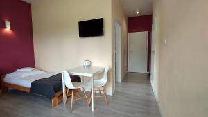 een slaapkamer met een bed, een tafel en stoelen bij Rezydencja Ostoja in Stronie Śląskie