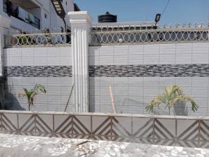 a building with palm trees in front of it at Kim's 2 bedroom Apartment in Jarbang +5 photos