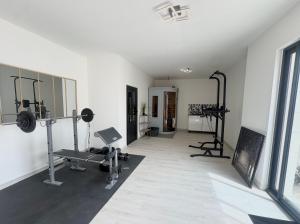 a room with a gym with weights and tread machines at Chambre double centre ville Bergerac in Bergerac