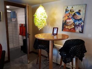 a table and two stools in a room at The Village Studio Apartments in Moate