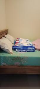 a unmade bed with a blanket on top of it at Safira in Ngadisari
