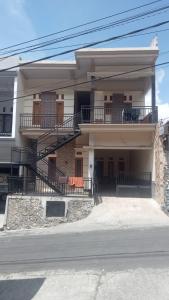 a house with a balcony and stairs on it at Safira in Ngadisari