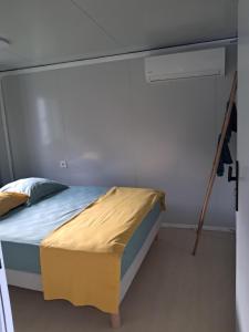 a bedroom with a bed in a room with a ladder at Villa Océanne in Grand-Bourg