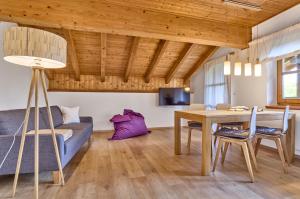 a living room with a table and a couch at Landhaus Lerchenweg FeWo inkl aktivCARD in Neuschönau