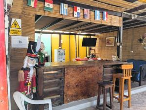 a bar with a person in a top hat at Arrullos del Mar in Zorritos
