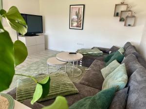 a living room with a couch and a table at Ferienhaus am Hang in Bad Wurzach