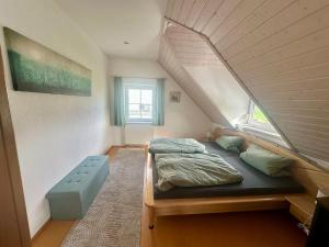 a bedroom with a bed in a attic at Ferienhaus am Hang in Bad Wurzach