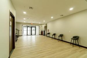 an empty room with stools in the middle of a hall at Efficiency De Luxe Sulphur Near Lake Charles I 10 in Sulphur