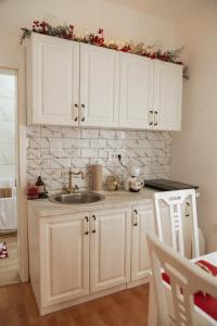 a kitchen with white cabinets and a sink at Chic&Vrdnik in Vrdnik +22 photos