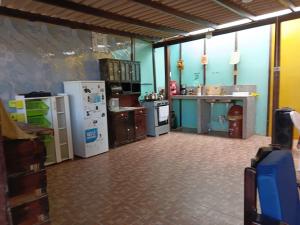 a kitchen with refrigerators and appliances in a room at Arrullos del Mar in Zorritos +8 photos