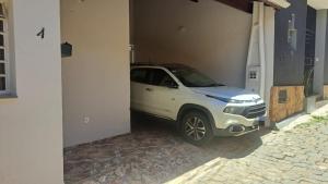 a white car is parked in a building at Morada dos Anjos in Aparecida