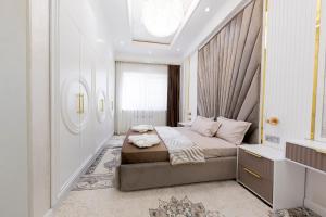 a bedroom with a bed and a window at Toshkent city apartments in Tashkent +120 photos