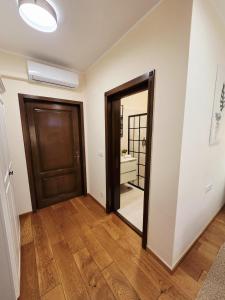 a hallway with a door and a mirror at Silent Retreat, Boutique Suite inside Monastery in Suceava