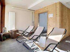 a row of chairs in a room with wooden walls at Appartement 5 pièces pour 10 pers · Proche pistes · Balcon · Sauna & Hammam - FR-1-344-135 in Les Menuires