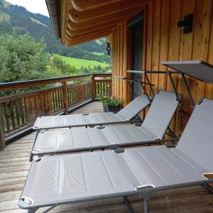 three lounge chairs on a deck on a cabin at Apartchalet Sisi- including Saalfelden Leogang Card in Saalfelden am Steinernen Meer