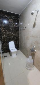 a bathroom with a toilet and a shower at SRI KRISHNA LODGE in Hosūr