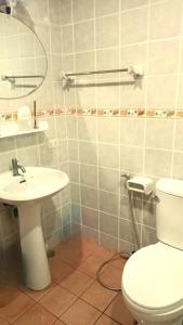 a bathroom with a white toilet and a sink at Jasmine's Bungalow in Ban Saiyuan (1) +58 photos