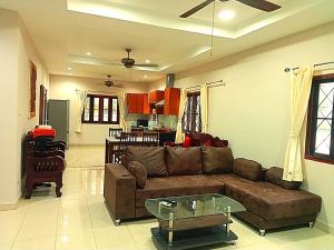 a living room with a couch and a table at Jasmine's Bungalow in Ban Saiyuan (1)