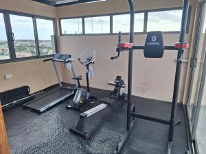 a gym with two treadmills and two ellipticals at Lumea Apartment in Flic-en-Flac