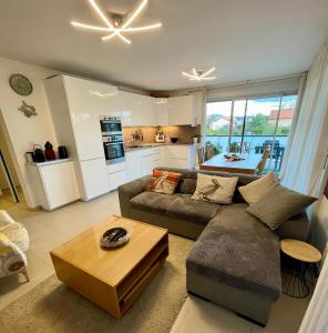 a living room with a couch and a table at Flo location Fréjus in Fréjus