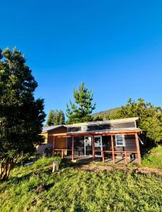 a house on top of a hill with trees at Cabaña Los Lagos 2 in Lenca