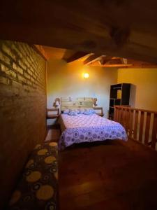 a bedroom with a bed in a dark room at Duplex lo de Aaron in El Bolsón
