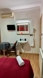 a room with a bed and a sink in a room at Pensión Laforja in Barcelona +42 photos