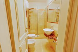 a bathroom with a shower and a toilet and a sink at Arpinelli Suite in Rome