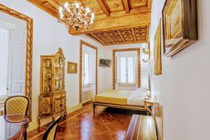 a bedroom with a bed and a chandelier at Arpinelli Suite in Rome