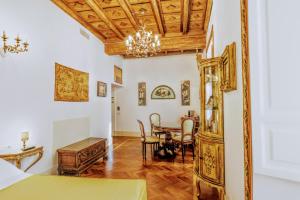 a bedroom with a dining room table and a mirror at Arpinelli Suite in Rome +16 photos