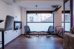 a living room with two chairs and a glass table at Star&spa in Niš