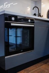 a black oven in a kitchen with a counter at Star&spa in Niš
