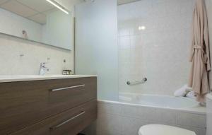 a bathroom with a tub and a toilet and a sink at Hampshire Hotel Petit Nord in Hoorn +37 photos