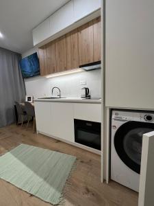a kitchen with a sink and a washing machine at Panorama Tatry Apartment in Jezersko