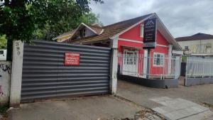 a garage door in front of a red building at Pousada Central Quarto 5 in Joinville