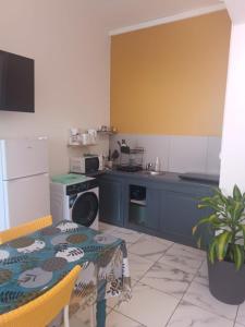 a kitchen with a table and a kitchen with a stove at Cocon zen in Saint-Pierre