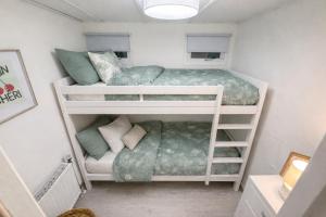 a small bedroom with two bunk beds in it at Ermway Cottage in Erm